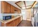 Kitchen featuring wooden cabinets, laminate countertops and updated flooring at 403 Woodridge Dr, Henderson, NV 89015