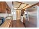 Traditional kitchen with wood cabinets, modern appliances, and wood laminate floors at 403 Woodridge Dr, Henderson, NV 89015
