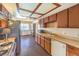 Efficient kitchen with wooden cabinets, modern appliances, and adjacent dining area at 403 Woodridge Dr, Henderson, NV 89015