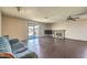 Open living room featuring a fireplace, sliding door to backyard, and vinyl flooring at 403 Woodridge Dr, Henderson, NV 89015
