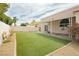 Spacious backyard with artificial turf and a covered patio for outdoor living at 434 Viewmont Dr, Henderson, NV 89015