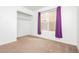 A bedroom with a window, closet, and neutral carpeting at 434 Viewmont Dr, Henderson, NV 89015