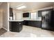 A kitchen featuring dark cabinetry, light countertops, and tile flooring at 434 Viewmont Dr, Henderson, NV 89015