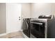 Modern laundry room with a washer and dryer and a door to the outside at 434 Viewmont Dr, Henderson, NV 89015