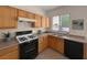 Efficient kitchen with light wood cabinets, modern appliances, and ample countertop space for meal preparation at 4439 Yellow Harbor St, Las Vegas, NV 89129