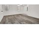 Bright living room features stylish gray wood flooring, crisp white walls, and abundant natural light at 4439 Yellow Harbor St, Las Vegas, NV 89129
