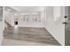 Bright, open-concept living room featuring stylish gray wood flooring and crisp white walls at 4439 Yellow Harbor St, Las Vegas, NV 89129
