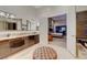 Sleek bathroom with double vanities, stone counters, and an open doorway to the main bedroom at 4515 Dean Martin Dr # 200, Las Vegas, NV 89103