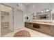 Elegant bathroom with double sinks, granite countertops, and a view into a walk-in closet at 4515 Dean Martin Dr # 200, Las Vegas, NV 89103