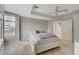Stylish bedroom with a large window, soft gray walls, and a king bed with a blue pillow at 4515 Dean Martin Dr # 200, Las Vegas, NV 89103