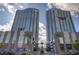 Two high-rise condo buildings with retail shops, palm trees and a blue cloudy sky at 4515 Dean Martin Dr # 200, Las Vegas, NV 89103