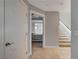 Hallway with tan floors, a white door, and a glimpse into the bedroom with stairs nearby at 4515 Dean Martin Dr # 200, Las Vegas, NV 89103