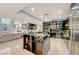 Open-concept kitchen featuring stainless steel appliances and bar seating connected to the living area at 4515 Dean Martin Dr # 200, Las Vegas, NV 89103