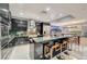 Modern kitchen with glossy black cabinets, stainless steel appliances, and a breakfast bar at 4515 Dean Martin Dr # 200, Las Vegas, NV 89103