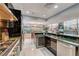 Open concept kitchen with stainless steel appliances, a wine fridge, and bar seating at 4515 Dean Martin Dr # 200, Las Vegas, NV 89103