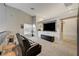Modern living room with a large TV, bar stools, and a cozy seating area at 4515 Dean Martin Dr # 200, Las Vegas, NV 89103