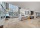Bright, open living room featuring tile floors, floor-to-ceiling windows, and a gray sectional sofa at 4515 Dean Martin Dr # 200, Las Vegas, NV 89103