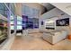 Spacious living room featuring tile floors, floor-to-ceiling windows, and a large sectional sofa at 4515 Dean Martin Dr # 200, Las Vegas, NV 89103