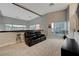 Bright living room with large windows, neutral carpet, and a comfortable leather sofa at 4515 Dean Martin Dr # 200, Las Vegas, NV 89103