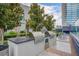 An outdoor kitchen area with stainless steel grills, granite countertops, and seating for alfresco dining at 4515 Dean Martin Dr # 200, Las Vegas, NV 89103