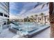 Stunning view of the community pool with ample seating, lush palm trees, and modern design at 4515 Dean Martin Dr # 200, Las Vegas, NV 89103