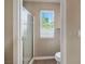 Bathroom with a glass shower door, toilet, and natural light at 4517 Rodman Dr, Las Vegas, NV 89130