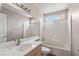 Bathroom with large mirror, combination tub and shower with tiled walls at 4517 Rodman Dr, Las Vegas, NV 89130