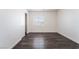 Neutrally decorated bedroom with gray wood-look floors, window, and closet at 4608 Snake Eyes St # 102, Las Vegas, NV 89122