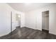 Brightly lit bedroom features gray wood-look floors, a closet, and doorway at 4608 Snake Eyes St # 102, Las Vegas, NV 89122