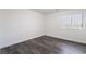 Neutral bedroom with gray wood-look floors and natural light, inviting for a comfortable retreat at 4608 Snake Eyes St # 102, Las Vegas, NV 89122