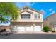 Inviting townhome featuring a three-car garage and neutral stucco exterior, perfect for modern living at 4608 Snake Eyes St # 102, Las Vegas, NV 89122