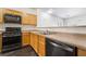 Spacious kitchen featuring modern black appliances, wood cabinets, and an open layout for easy entertaining at 4608 Snake Eyes St # 102, Las Vegas, NV 89122
