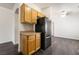 The kitchen area showcases wooden cabinets and black appliances, complementing the modern flooring and open layout at 4608 Snake Eyes St # 102, Las Vegas, NV 89122