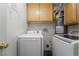 Efficient laundry area with modern washer, dryer and upper cabinets, designed for convenience at 4608 Snake Eyes St # 102, Las Vegas, NV 89122