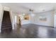 Spacious open-concept living room with hardwood flooring, adjacent to the kitchen with staircase access at 4608 Snake Eyes St # 102, Las Vegas, NV 89122