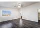 Spacious primary bedroom showcasing wood-style flooring, a ceiling fan, and plenty of natural light from a large window at 4608 Snake Eyes St # 102, Las Vegas, NV 89122