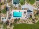 Aerial view of a community pool with sunbathing area and palm trees, perfect for relaxation and recreation at 4650 Ridgeley Ave # 103, North Las Vegas, NV 89084