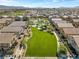 Aerial view of a well-maintained community featuring a large grassy area, swimming pool, and residential homes at 4650 Ridgeley Ave # 103, North Las Vegas, NV 89084