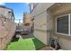 Cozy backyard features artificial grass, string lights, BBQ, and seating area, perfect for outdoor enjoyment at 4650 Ridgeley Ave # 103, North Las Vegas, NV 89084