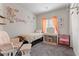 Charming bedroom features a vanity area, a comfortable chair, and floral wall decor at 4650 Ridgeley Ave # 103, North Las Vegas, NV 89084