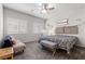 Neutral bedroom with a queen bed, ceiling fan, and carpet flooring at 4650 Ridgeley Ave # 103, North Las Vegas, NV 89084