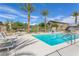 Community pool featuring lounge chairs, palm trees, and clear blue skies, a relaxing atmosphere at 4650 Ridgeley Ave # 103, North Las Vegas, NV 89084