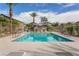 Community pool featuring lounge chairs, palm trees, and clear blue skies, promoting a relaxing atmosphere at 4650 Ridgeley Ave # 103, North Las Vegas, NV 89084
