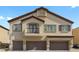 Beautiful three-story home featuring three-car garage and classic desert architecture with a balcony at 4650 Ridgeley Ave # 103, North Las Vegas, NV 89084