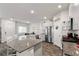 Bright kitchen with stainless steel appliances, white cabinets, granite counters, and a view into the dining area at 4650 Ridgeley Ave # 103, North Las Vegas, NV 89084