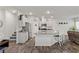 Well-lit kitchen featuring a granite island, modern appliances, and open-concept layout with an adjacent staircase at 4650 Ridgeley Ave # 103, North Las Vegas, NV 89084