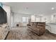 Open-concept living area features wood floors, neutral paint and a cozy brown sofa at 4650 Ridgeley Ave # 103, North Las Vegas, NV 89084