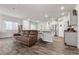 Open-concept living space with wood floors, white walls, modern lighting, and stainless appliances at 4650 Ridgeley Ave # 103, North Las Vegas, NV 89084