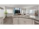 Open-concept living space featuring a modern kitchen island seamlessly flowing into a cozy living area at 4650 Ridgeley Ave # 103, North Las Vegas, NV 89084