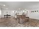 Spacious, open floor plan featuring hard surface floors, a brown sofa, and modern decor at 4650 Ridgeley Ave # 103, North Las Vegas, NV 89084